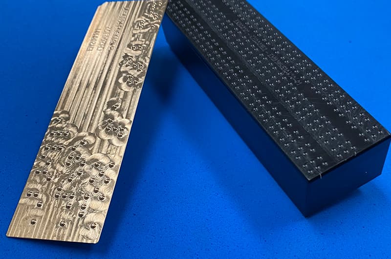 Braille tooling raising dots on a pharmaceutical carton