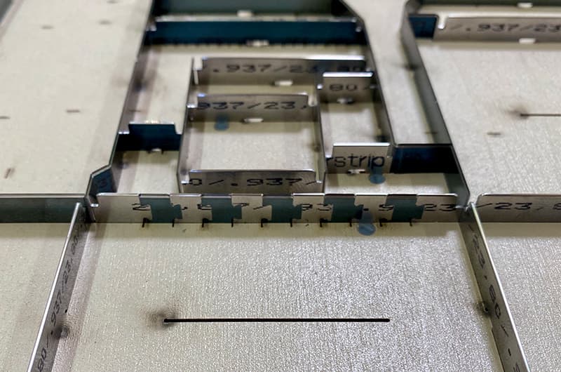 Custom-profile steel rule with rule heights stamped along the blade