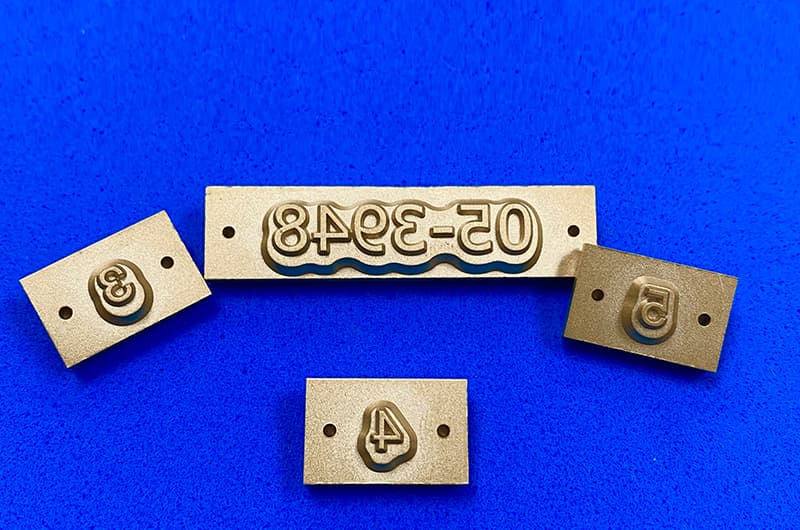 Deboss slugs machined for a carton panel