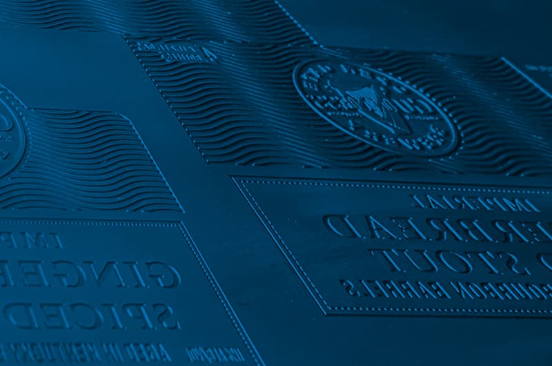 Machined embossing die showing stepped relief