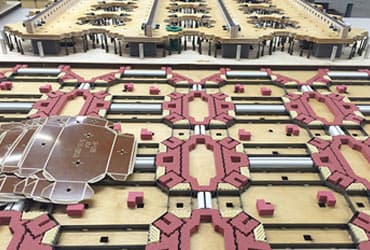 Press-ready cutting die for a carton converter, rule and pink ejection rubber set across the board